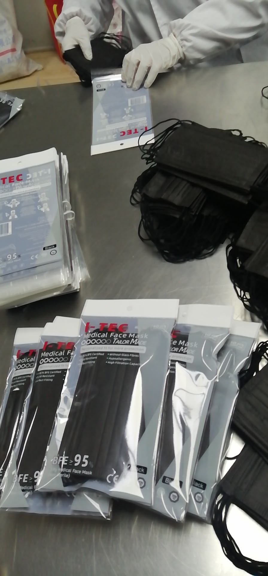 I-TEC staff packing finished I-TEC branded face masks at our facility